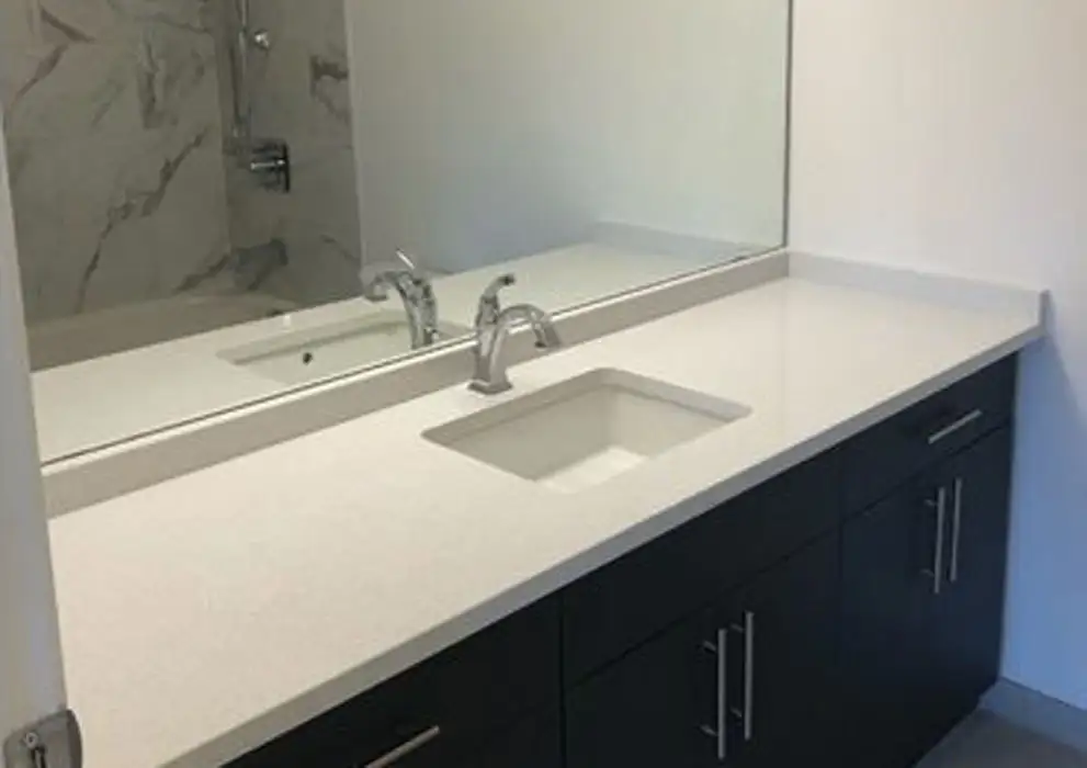 An interior renovation featuring a white sink and mirror in the bathroom
